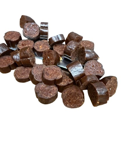 A pile of dehydrated chicken sausage dog treats.